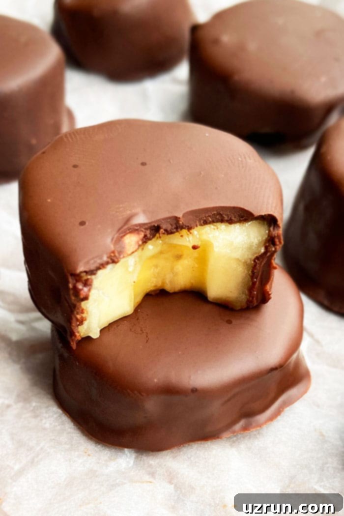 Stack of Frozen Chocolate Covered Bananas Bites on White Parchment Paper - a perfect healthy snack or dessert