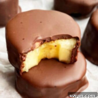 Chilled Chocolate Banana Delights 5 Stack of Frozen Chocolate Covered Bananas Bites on White Parchment Paper