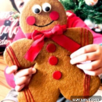 King-Sized Gingerbread Men 7 Kid Holding Jumbo Gingerbread Men Cookies With Christmas Decor in Background
