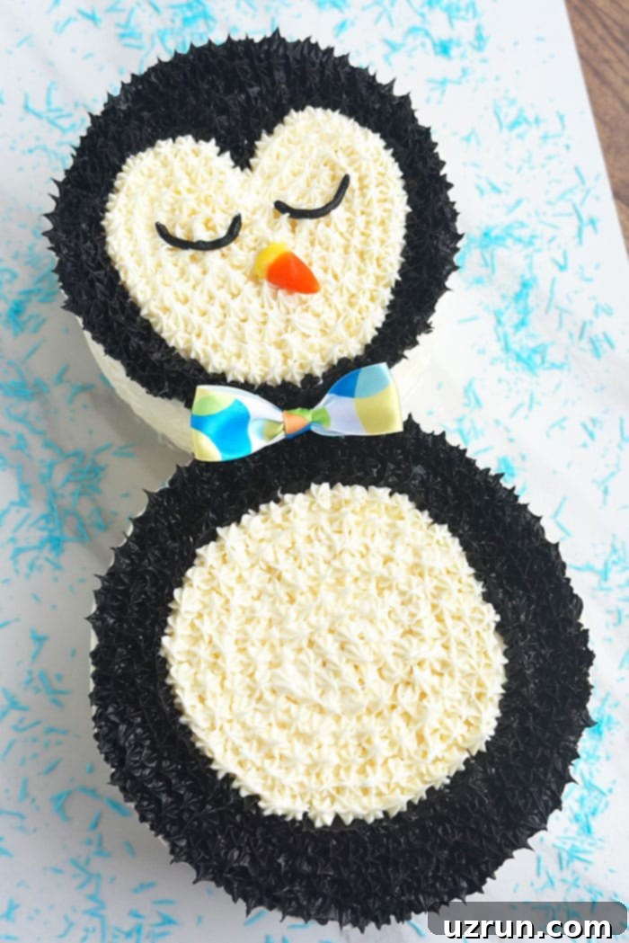Easy Penguin Cake With Buttercream Icing on White Background With Blue Sprinkles