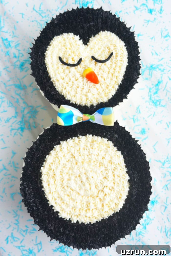 Effortless Penguin Cake with Silky Buttercream 5 Decorated Winter Animal Cake on White Background With Blue Sprinkles