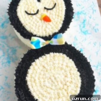 Effortless Penguin Cake with Silky Buttercream 8 Easy Penguin Cake With Buttercream Icing on White Background With Blue Sprinkles