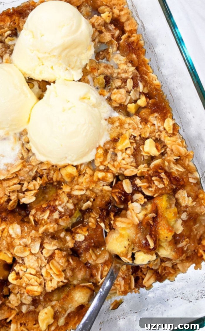 Effortless Banana Crumble 3 Easy Homemade Banana Crumble in Glass Dish with Scoops of Vanilla Ice Cream