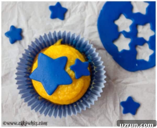 Easy Marshmallow Fondant Recipe 4 Cupcake Decorated With Blue Fondant Star Cupcake Toppers on Dull Gray Background