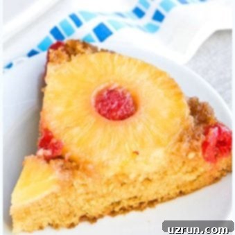 Easy Pineapple Upside Down Cake Slice on White Dish.