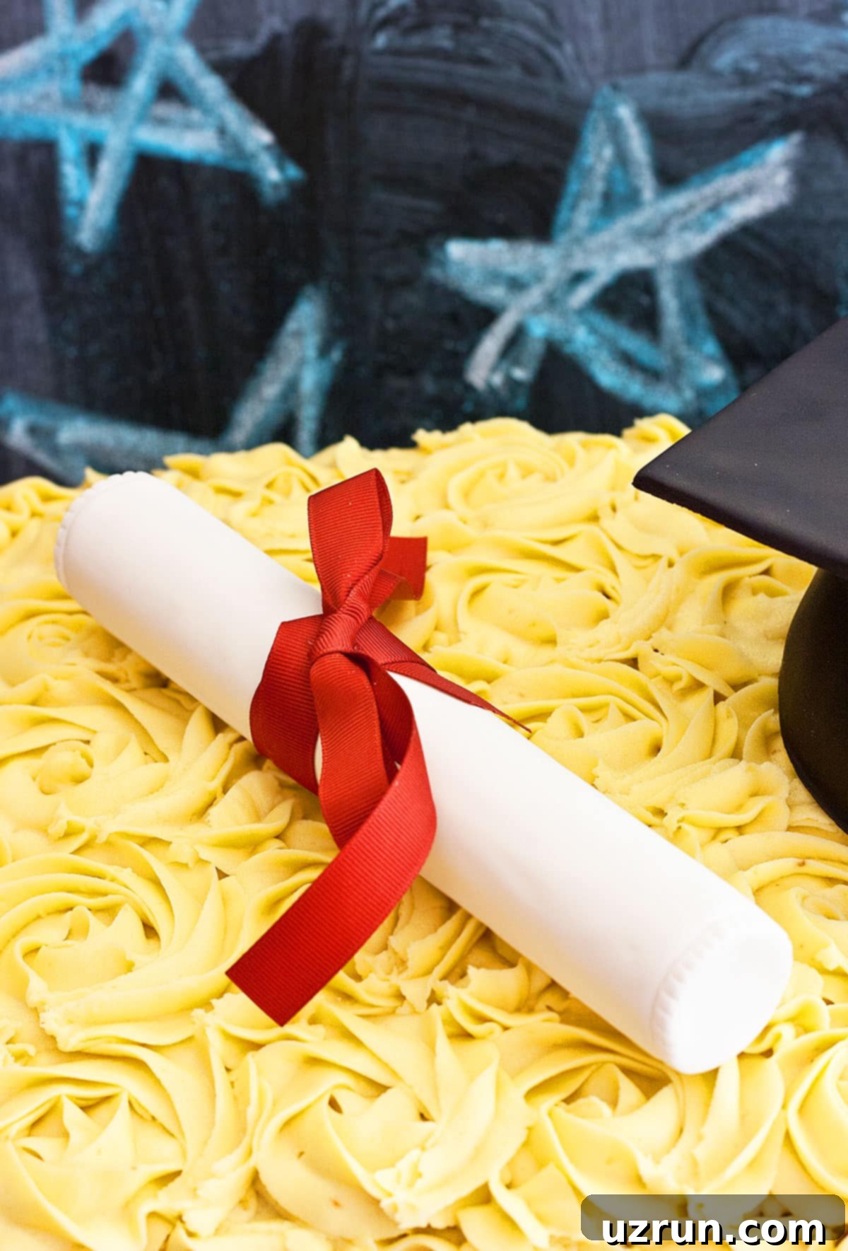 Easy Graduation Cake with Cap and Diploma 4 Close-up of an Edible Rice Krispie Treat Diploma with a Red Bow on a Graduation Cake.