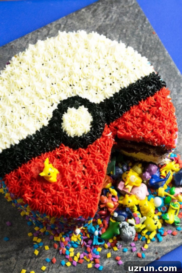 Quick and Easy Pokeball Cake 3 Homemade Pokemon Cake With One Slice Removed, revealing colorful sprinkles and small Pokemon toys inside the pinata center.