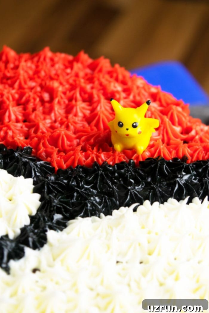 Quick and Easy Pokeball Cake 4 Easy Homemade Birthday Cake With Closeup Shot of Tiny Pikachu Toy, showing the intricate buttercream star piping detail.