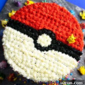 Quick and Easy Pokeball Cake 7 Easy Pokemon Cake (Pokeball Cake) on Square Gray Plate- Overhead Shot, a vibrant red and white cake with a black stripe, adorned with buttercream stars.