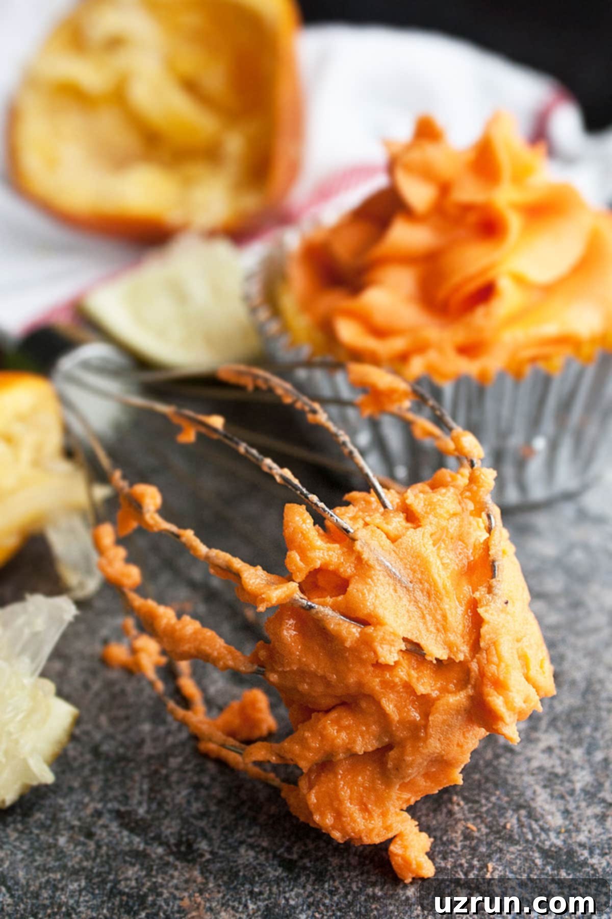 Easy Orange Buttercream Frosting 3 Spatula With Orange Creamsicle Icing on Rustic Gray Background.