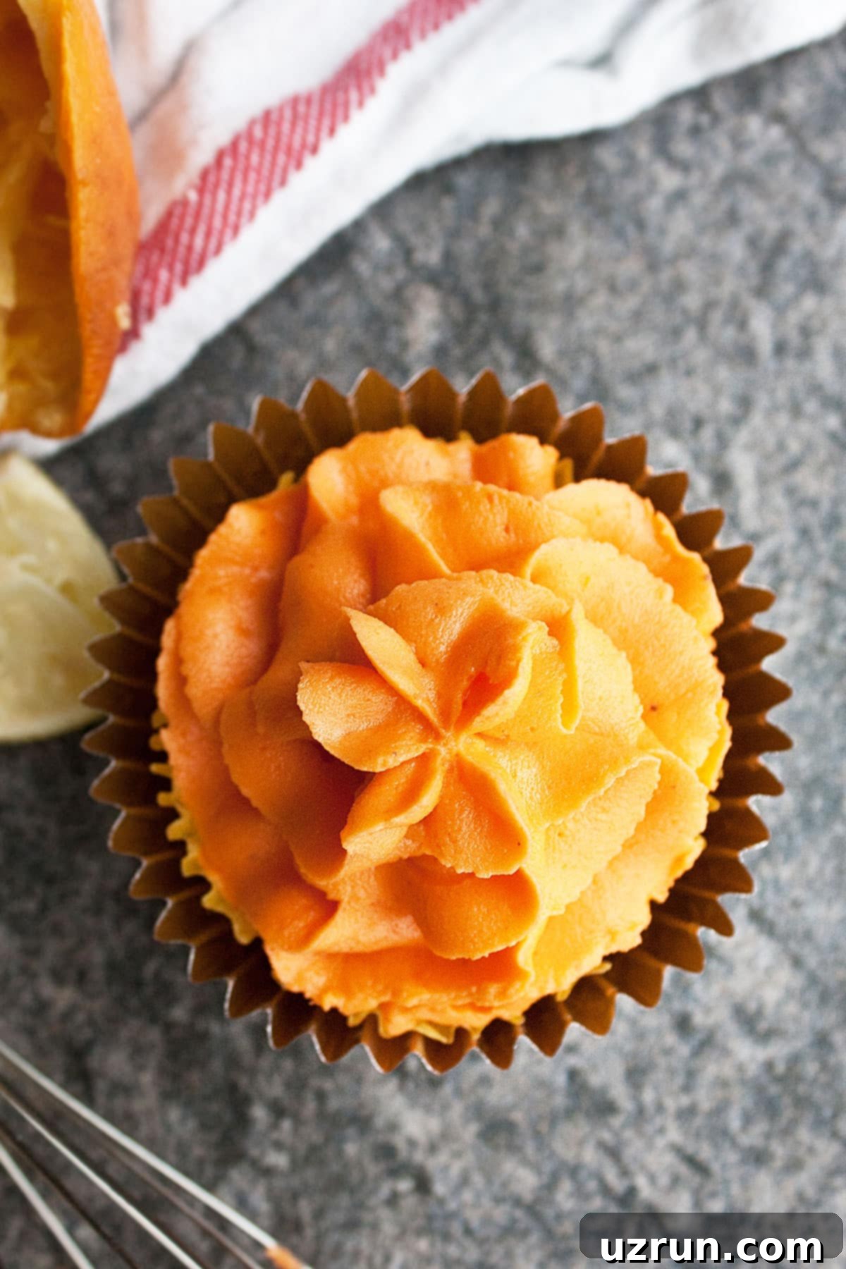Easy Orange Buttercream Frosting 4 Closeup Shot of a Swirl of Icing on Top of Cupcake.