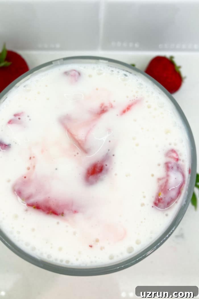 Mexican Strawberry Cream Delight 3 Homemade Mexican Strawberries and Cream in Glass Cup on White Background- Overhead Shot