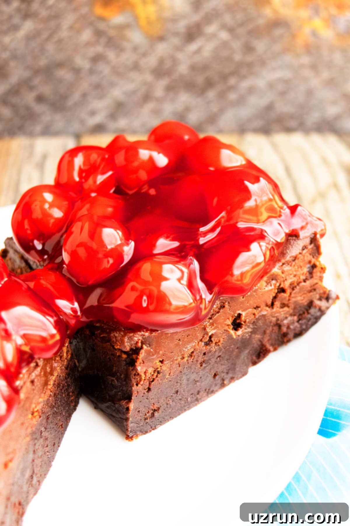 Dark Chocolate Cherry Fudge Brownies 12 Easy Homemade Brownies on White Plate With Rustic Background.