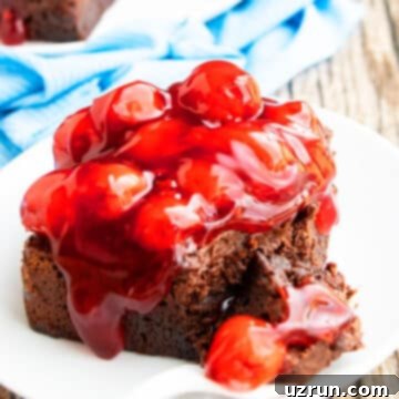 Dark Chocolate Cherry Fudge Brownies 13 Slice of Gooey Brownies (Chocolate Cherry Brownies) on White Dish With Fork.