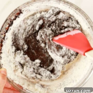 Dark Chocolate Cherry Fudge Brownies 8 Flour added to batter in glass bowl.