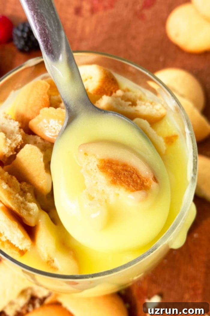 Homemade No Bake Banana Pudding 3 Spoonful of Best Old Fashioned Pudding with Vanilla Wafers Over Glass Cup, highlighting its creamy texture