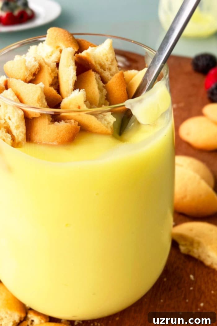 Homemade No Bake Banana Pudding 4 Easy Banana Pudding From Scratch in Glass Cup with a silver spoon, ready to be enjoyed