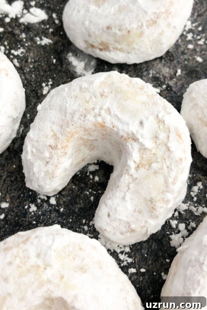 Almond Crescent Cookies 2 Classic Almond Crescent Cookies (Vanillekipferl) on Grayish Black Background- Overhead Shot