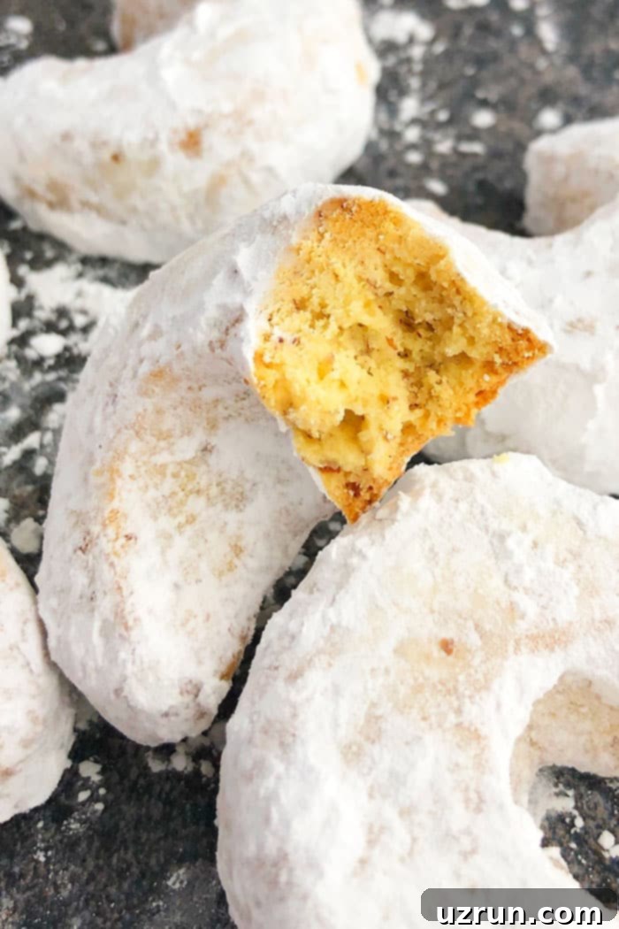 Almond Crescent Cookies 3 Easy Almond Crescents With One Bite Removed- Closeup Shot