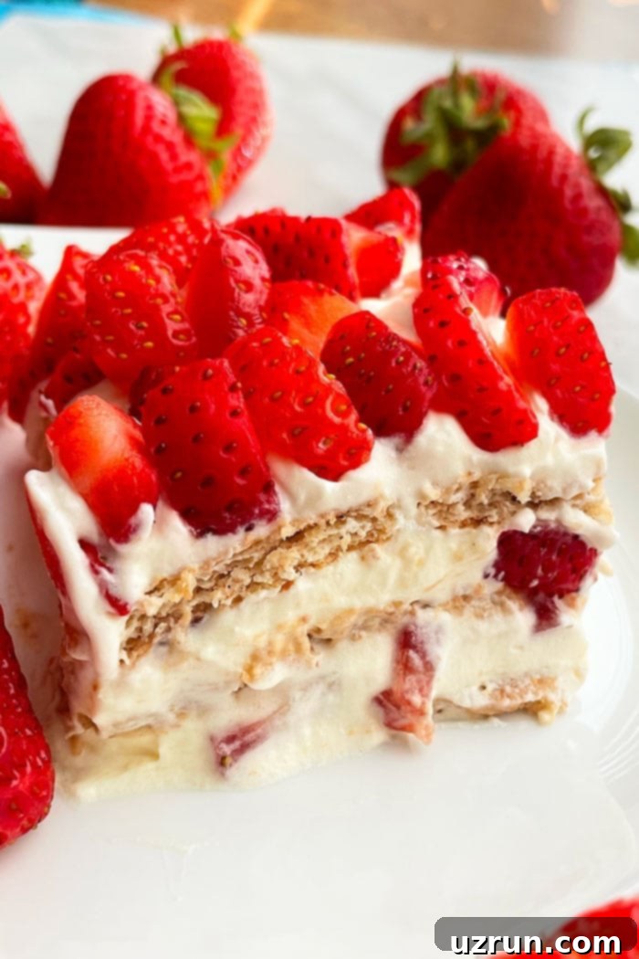 Slice of Traditional No Bake Refrigerator Cake With Strawberries on White Plate