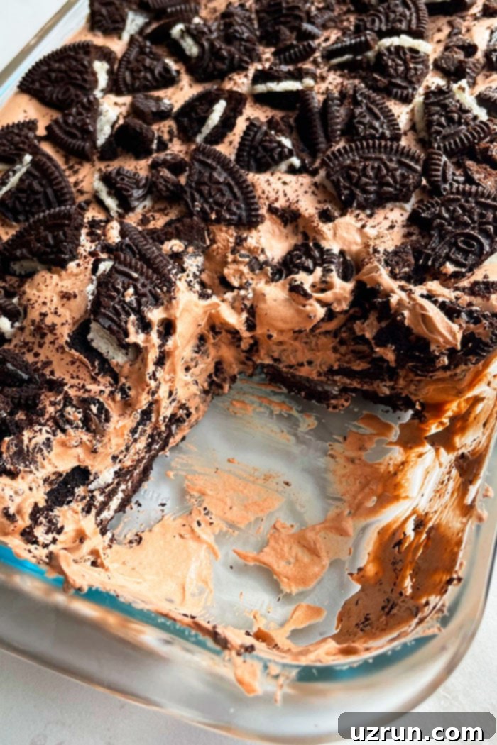 No-Bake Chocolate Oreo Icebox Cake 3 Easy No Bake Oreo Chocolate Icebox Cake in Glass Dish- One Slice Removed