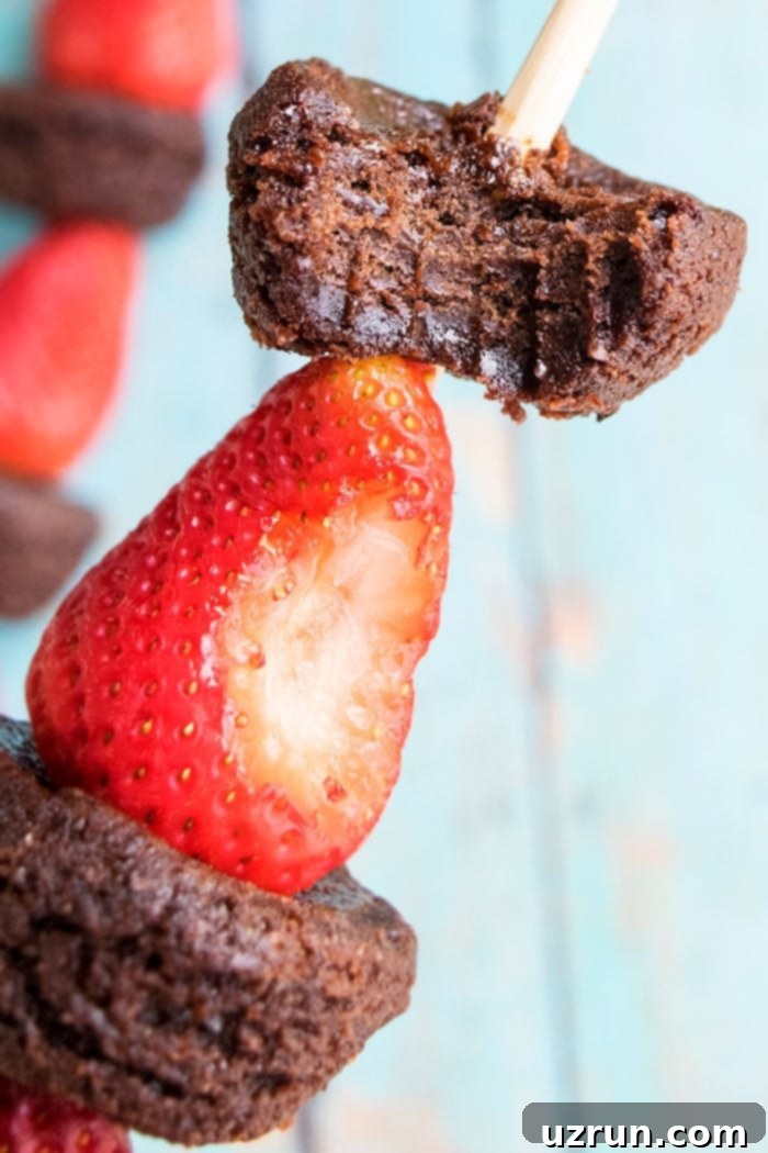 Simple Fruit Skewers 3 Partially Eaten Fruit Skewers With Strawberries and Chocolate Brownies