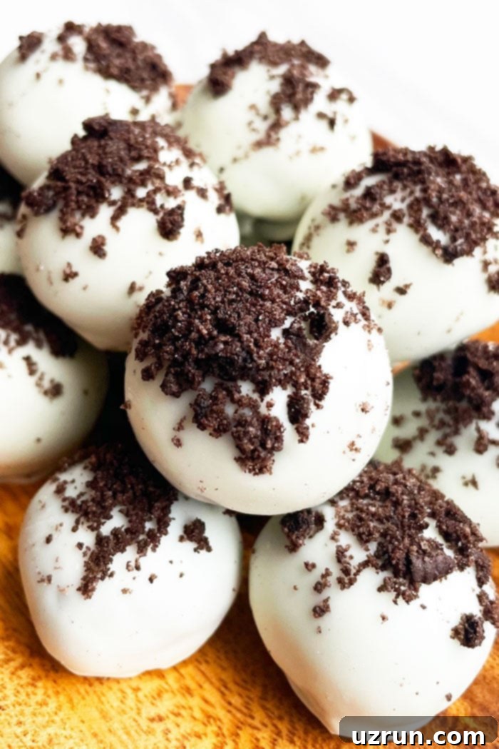Stack of decadent No-Bake Oreo Truffles in a Rustic Wooden Plate, ready to be enjoyed.