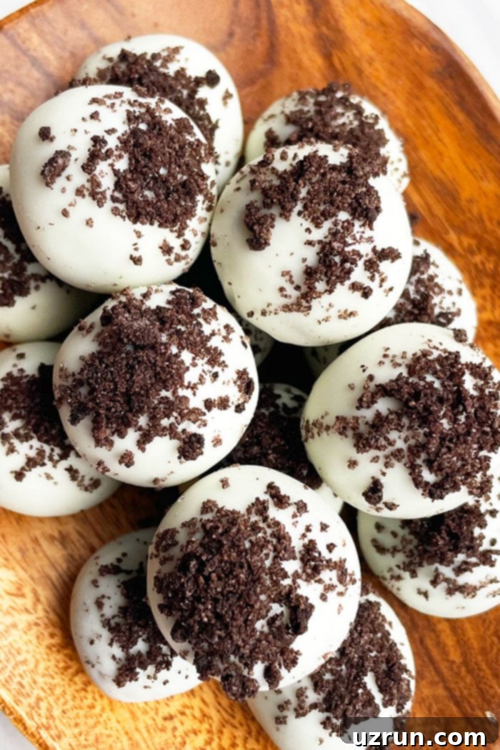 Oreo Truffles 4 Overhead shot of easy homemade No-Bake Oreo Truffles in a rustic Wooden Plate, beautifully presented.