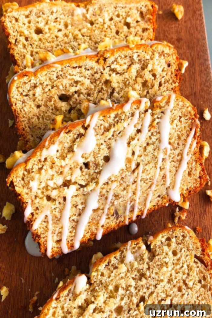 Easy Cake Mix Banana Bread 5 Slice of Moist Banana Bread With Vanilla Glaze on Brown Wood Background