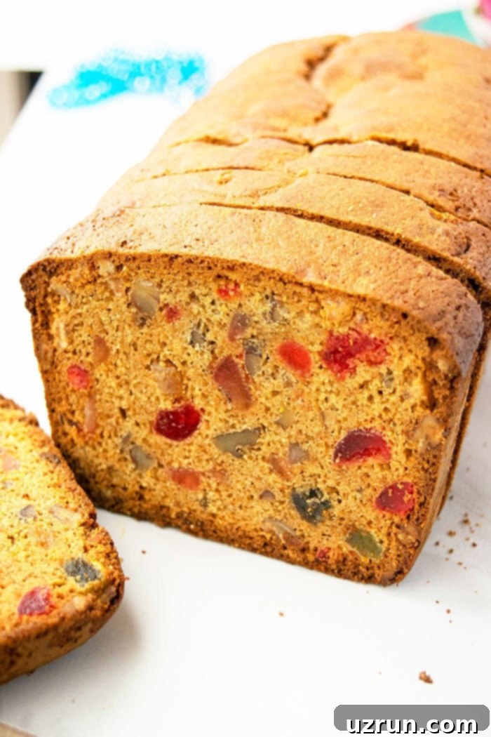 Effortless Christmas Fruit Cake Using Cake Mix 5 A festive Christmas fruit cake presented beautifully on a white background, ready for holiday celebrations.