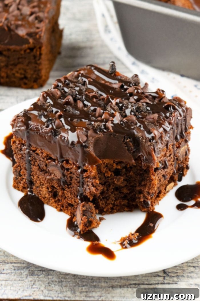 Slice of Partially Eaten Easy Coca Cola Cake With Cake Mix on White Plate