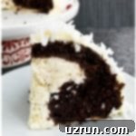 Cake Mix Desserts Made Easy 22 Slice of Easy Snowball Cake Stuffed With Cheesecake on White Dish.
