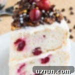 Cake Mix Desserts Made Easy 35 Slice of Christmas Cranberry Cake With Coconut and Cream Cheese Frosting on White Dish.