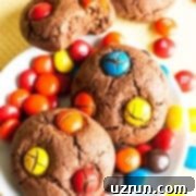 Cake Mix Desserts Made Easy 69 Easy Chocolate M&M Cookies With Cake Mix on White Dish and Yellow Background.