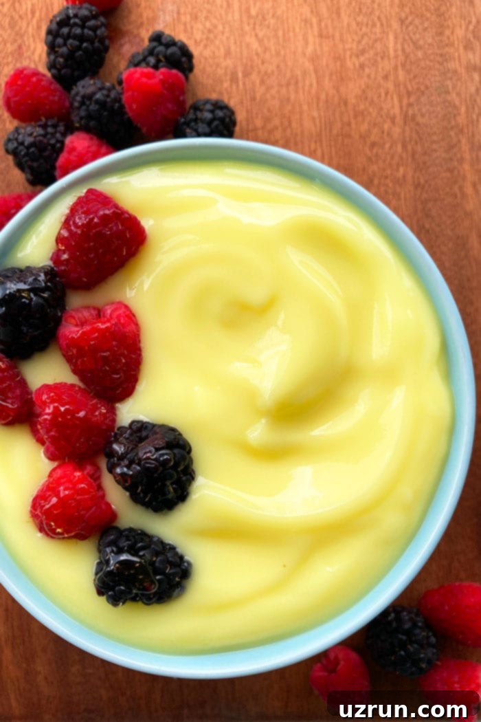 Egg Custard With Fresh Berry Topping in Blue Bowl- Overhead Shot