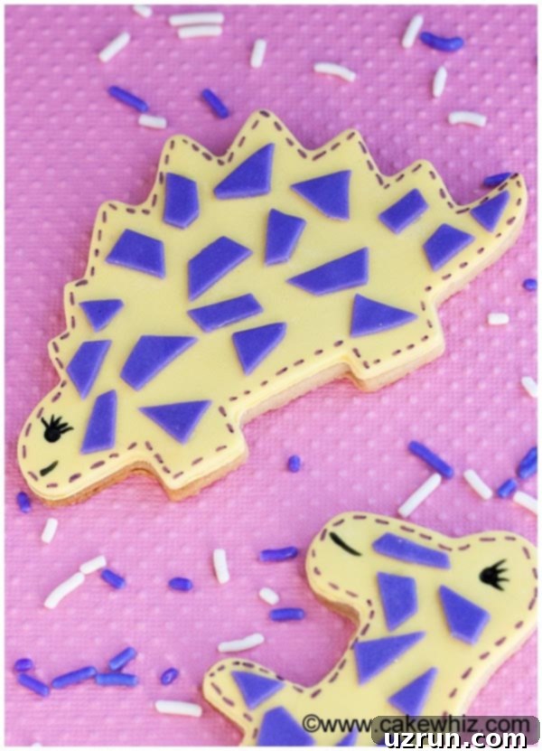 Roarsome Easy Dinosaur Cookies 3 Homemade Dino Cookies Decorated With Fondant on Pink Background
