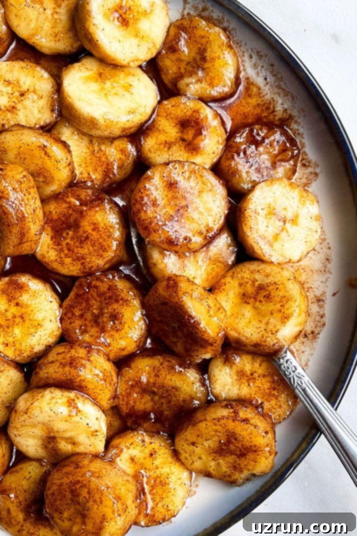 Easy Cinnamon Caramel Bananas 2 Easy Pan Fried Caramelized Bananas in White Dish With Black Rim- Overhead Shot