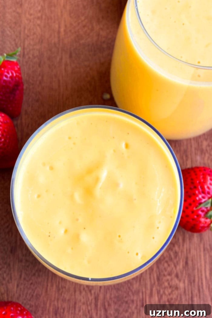 Creamy Indian Mango Lassi 3 Closeup Shot of Homemade Mango Yogurt Drink in Glass Cup- Overhead Shot