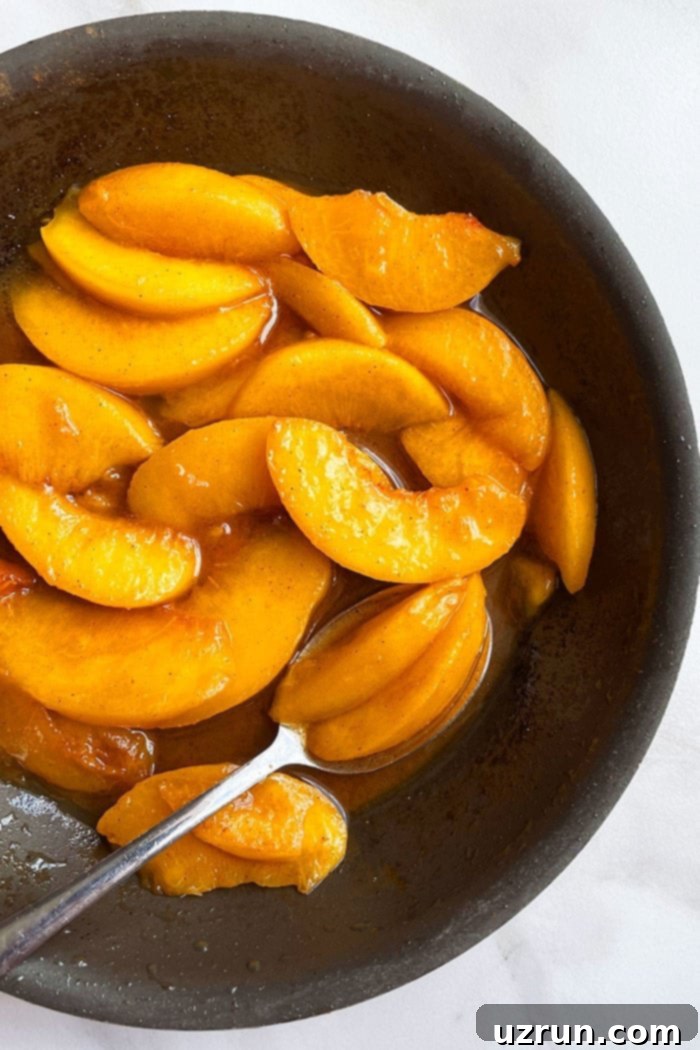 Caramelized Cinnamon Baked Peaches 4 Stovetop Peaches in Brown Sugar Syrup in Nonstick Pan- Overhead Shot