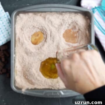 No Fuss Chocolate Cake 7 Filling depressions with oil, vinegar, and vanilla.
