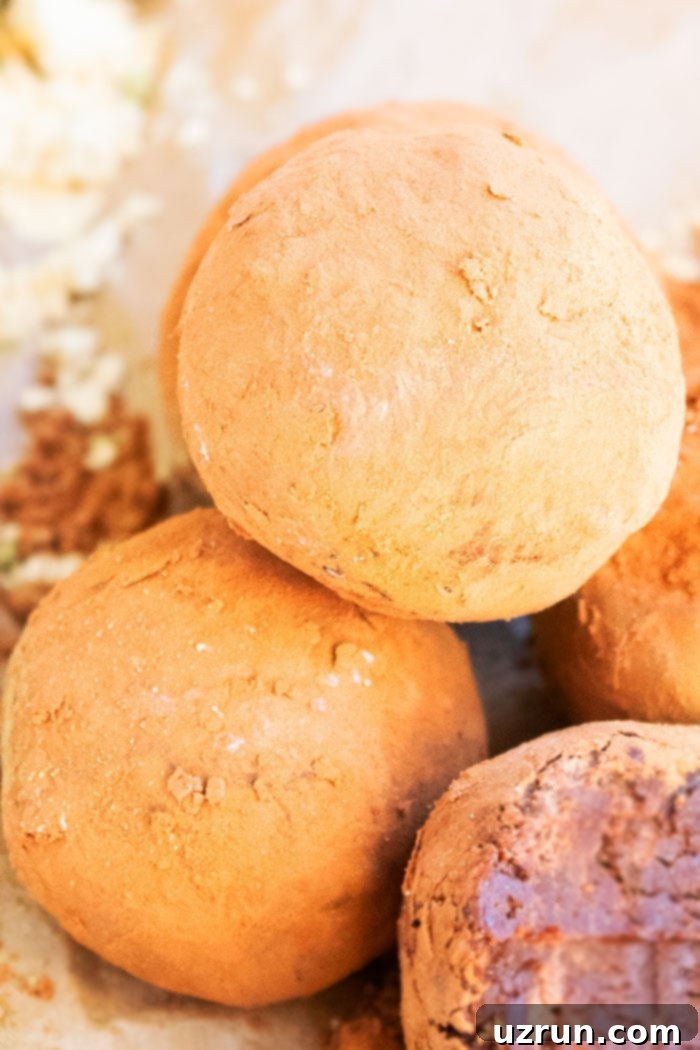 Easy 4-Ingredient Champagne Truffles 3 Stack of Easy Homemade Chocolate Truffles Rolled in Cocoa Powder on Brown Paper