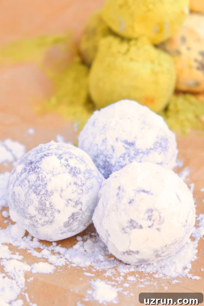 Easy 4-Ingredient Champagne Truffles 5 Truffle Balls Rolled in Powdered Sugar on Brown Paper