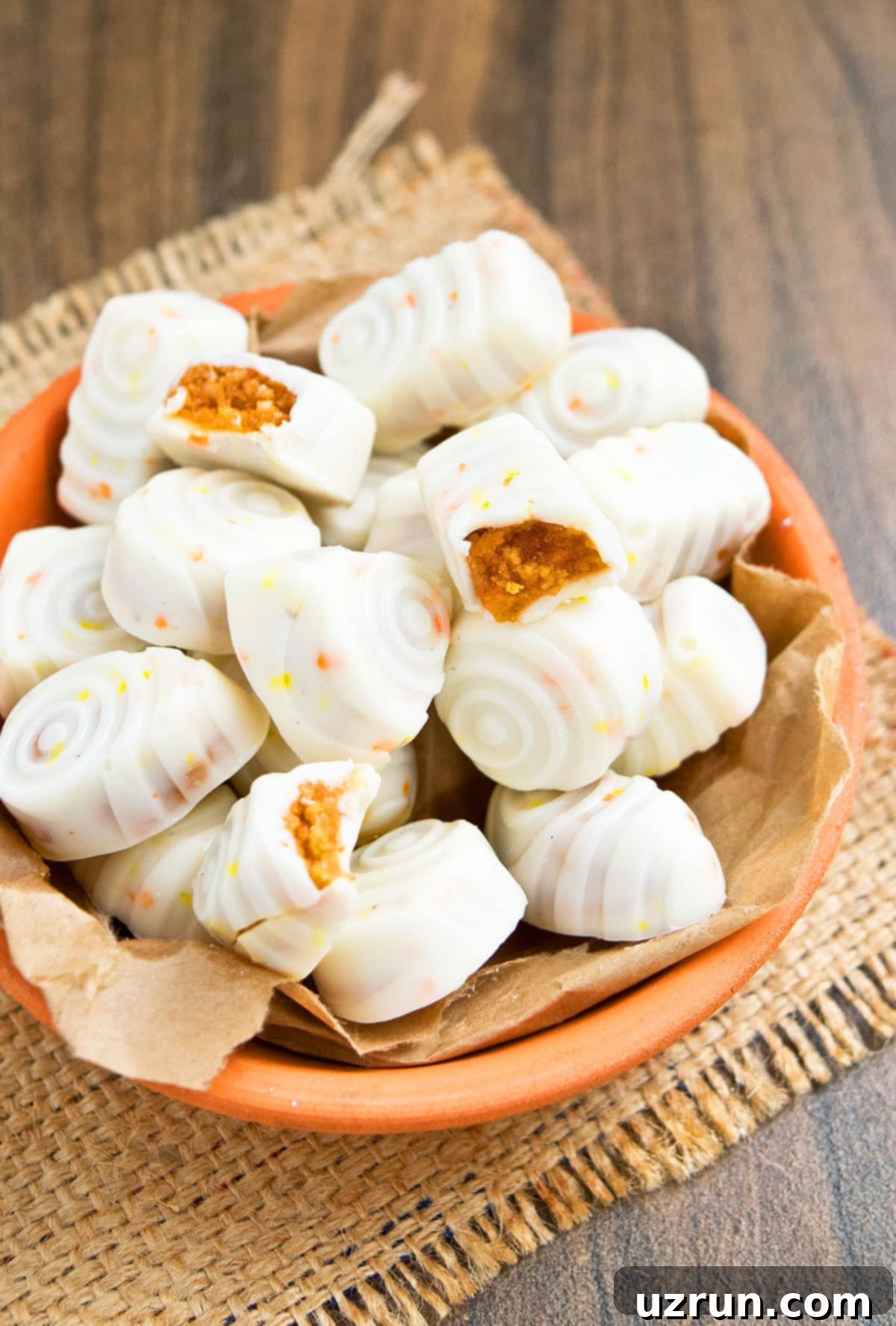Easy Pumpkin Truffles in Orange Dish With Some Partially Eaten Ones. 