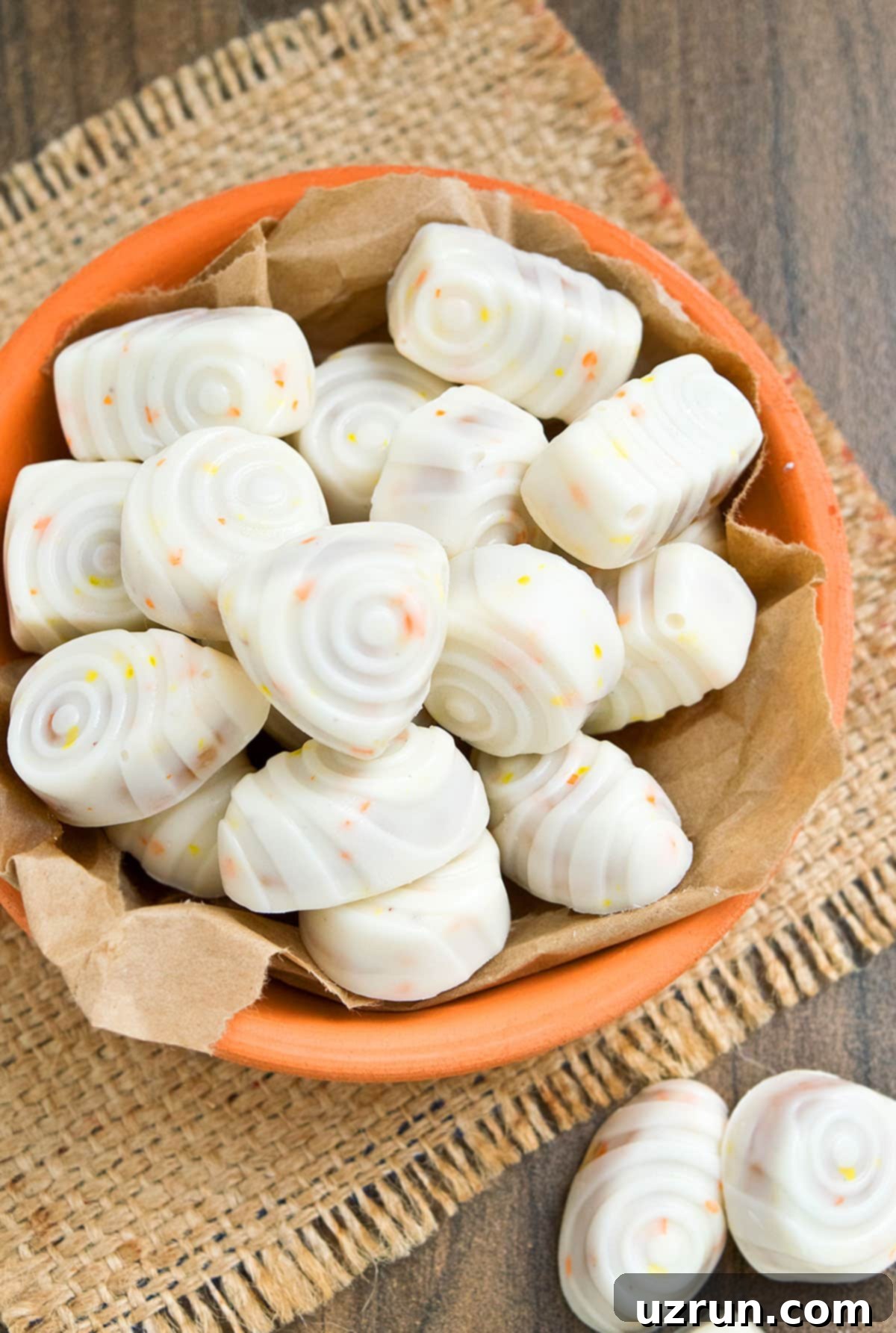 Easy Pumpkin Cheesecake Truffles 3 Homemade Pumpkin Cheesecake Truffles in Orange Dish.
