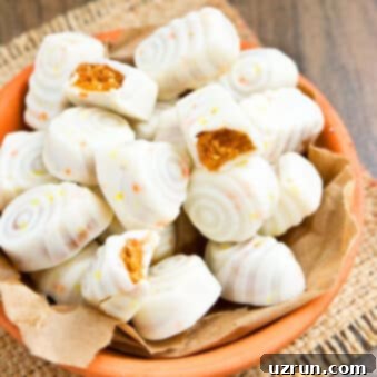 Easy Pumpkin Cheesecake Truffles 6 Easy Pumpkin Truffles in Orange Dish With Some Partially Eaten Ones.