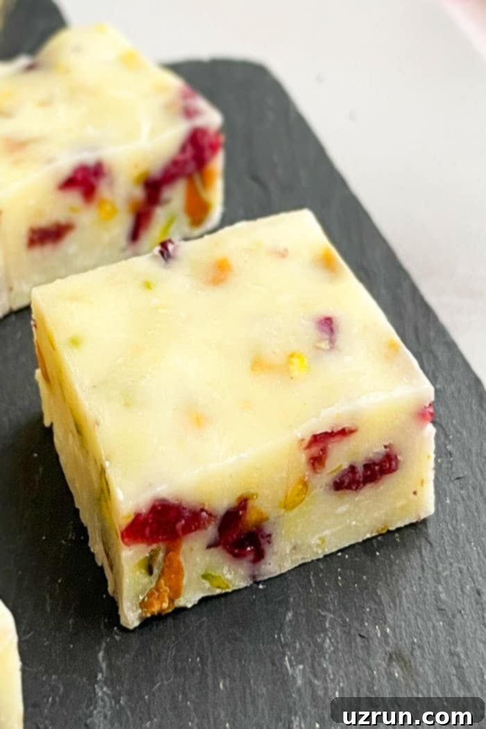 Cranberry Pistachio Condensed Milk Fudge 4 Closeup Shot of Slice of Cranberry Pistachio Fudge on Black Base