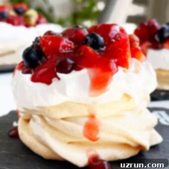 Mini Pavlovas with Whipped Cream and Berries 5 Easy Mini Pavlova With Whipped Cream and Fresh Berries on Black Dish, a visually appealing dessert.