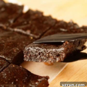 No-Bake Date Bars 8 Closeup shot of tongs holding a slice or bar.