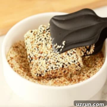 No-Bake Date Bars 10 Bar being coated in sesame seeds on the other side.