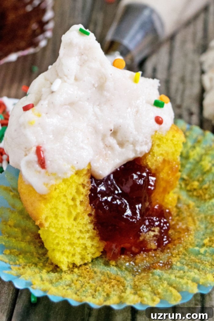 Easy Jam Filled Cupcakes (Stuffed Cupcakes) on Rustic Wood Background